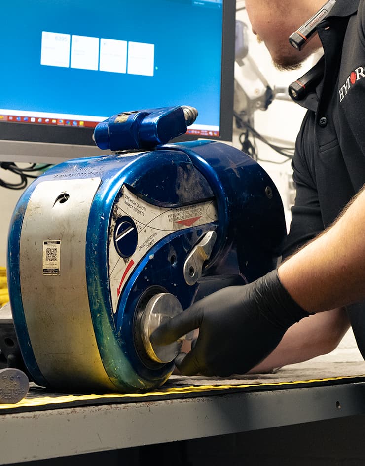 A HYTORC technician repairing an MXT Hydraulic Torque Wrench